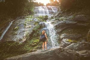 as mulheres viajam. mulher viajantes da Ásia viajam por florestas naturais, montanhas, cachoeiras