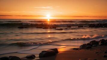 uma pôr do sol sobre a oceano com pedras em a de praia foto