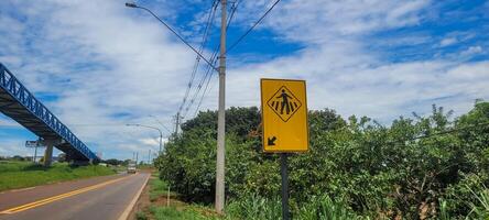 pedestre placa em pavimentou estrada foto