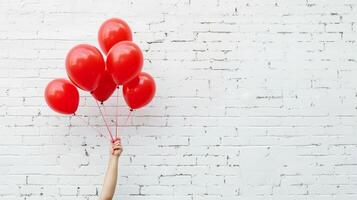uma pessoa é segurando uma grupo do vermelho balões foto
