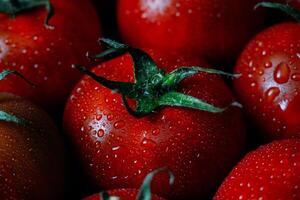 uma fechar acima do uma grupo do tomates com água gotas foto