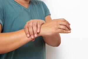 segurando mão homem com dor dentro músculos e articulações, sintomas do periférico neuropatia e dormência dentro a ponta do dedo e palma, doenças causou de lado efeitos do vacinação, Guillain barre síndrome gbs foto