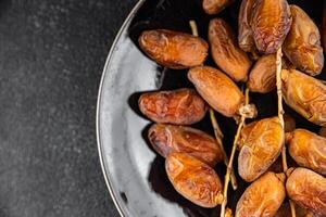 encontro em uma ramo seco doce fruta fresco refeição Comida lanche em a mesa cópia de espaço Comida fundo foto