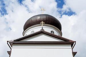 a cúpula do a Igreja igreja, a branco construção do a ortodoxo igreja, a dourado cruzes em a cobertura do a casa, tranqüilidade, paz, arrependimento. foto