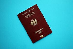 vermelho alemão Passaporte do europeu União em azul fundo fechar acima foto