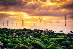 no mar vento turbina dentro uma vento Fazenda às pôr do sol dentro carro vermelho, yorkshire, Reino Unido foto