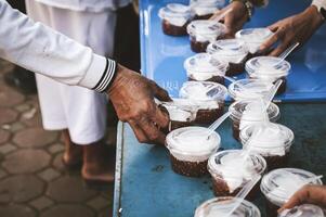 voluntários estão dando livre Comida para Socorro a com fome pobre conceito do Comida partilha foto