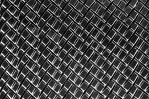 monocromático textura do uma brilhante metal escorredor de macarrão ou grato. abstrato fundo. foto