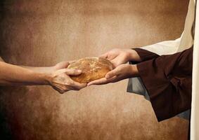 Jesus dá a pão para uma mendigo. foto