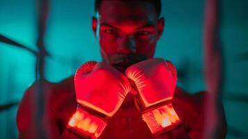 uma boxer usando a infravermelho luz terapia dispositivo em seus mãos para reduzir inchaço e impulso circulação. foto