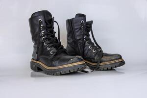 velho usava quebrado Preto couro exército renda botas. na moda outono botas. à moda mulheres masculino unissex grunge chuteiras com cadarço. Alto militares sapatos isolado em branco fundo. plano deitar. cópia de espaço foto