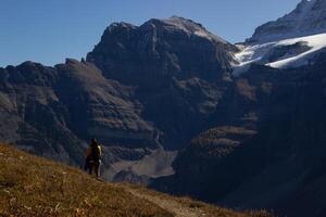 mulher caminhante caminhando através a rochoso montanhas do Canadá. foto