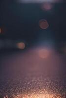 uma embaçado imagem do uma rua às noite com luzes foto