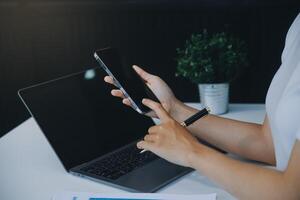 mulher asiática feliz animada olhando para a tela do telefone, comemorando uma vitória online, jovem mulher asiática muito feliz gritando de alegria, isolada sobre um fundo branco desfocado foto