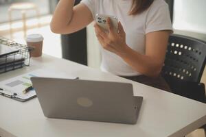 jovem adulto feliz sorridente estudante asiático latino-americano usando fones de ouvido falando na reunião de bate-papo on-line usando laptop no campus universitário ou no escritório virtual. estudante universitária aprendendo remotamente. foto