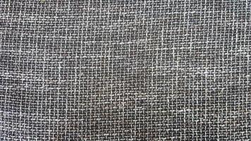 close-up de textura de tecido cinza, plano de fundo e papel de parede. a textura do tecido é cinza, estofamento têxtil. textura de tweed cinza, padrão de lã cinza foto