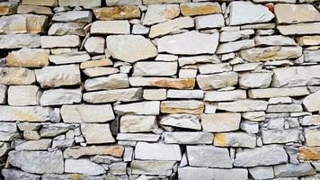 textura da parede de pedra como plano de fundo ou textura. padrão de cor cinza estilo moderno design decorativo rachaduras irregulares superfície real