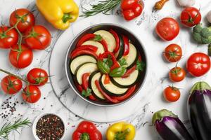 colorida sortimento do fresco ingredientes preparado para gourmet Ratatouille em uma chique branco mármore mesa foto