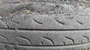 um pneu que é danificado após uso prolongado. um pneu de carro usado e rasgado em um ferro-velho. foto