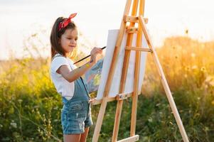 Educação, escola, arte e pintura conceito - pequeno aluna menina pintura cenário. foto