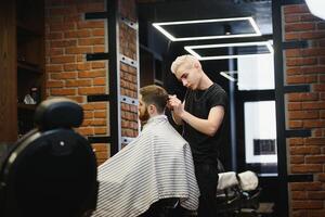 fechar-se, mestre cabeleireiro faz Penteado e estilo com tesouras e pentear. conceito barbearia foto