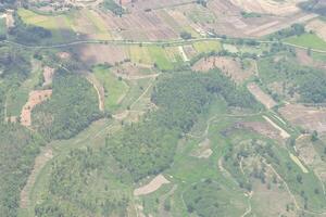 aéreo Visão do agrícola campo, rio e nuvens visto através avião janela foto