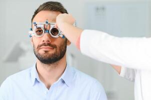 oftalmologia conceito. masculino paciente debaixo olho visão exame dentro visão oftalmológico correção clínica foto