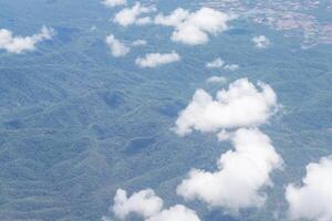 vista aérea de terras e nuvens vistas pela janela do avião foto