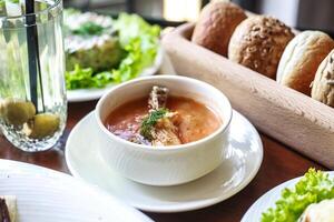 tigela do sopa com pão e salada em mesa foto