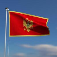 Montenegro bandeira é acenando dentro frente do uma azul céu com borrado nuvens dentro a fundo foto