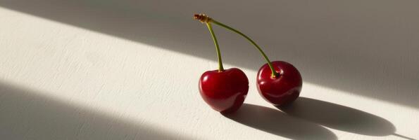 lustroso cerejas com rígido sombras em uma branco superfície foto