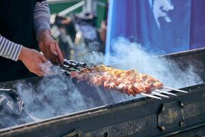 cozinhar churrasco de porco com cubos de espetos de carne na grelha para churrasco, prato tradicional da ásia central foto