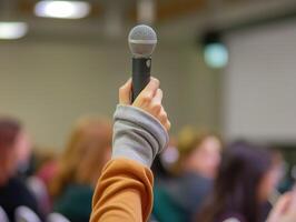 uma mão segurando acima uma microfone dentro uma profissional contexto, simbolizando a poder do discurso e comunicação. foto