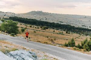 determinado atleta corrida através áspero montanha terreno às nascer do sol. foto