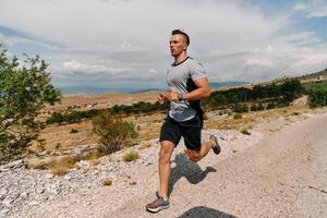 determinado atleta corrida através áspero montanha terreno às nascer do sol. foto