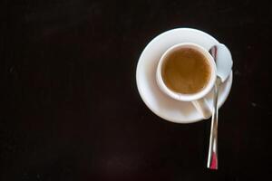 uma quente espresso café dentro cerâmico copo e pires. foto