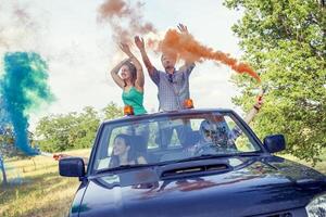 grupo do jovem rapazes ter Diversão com colori fumaça trilhas foto