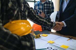 arquitetos e designers estão falando sobre construção planos antes ser entregue para a Engenharia equipe e capatazes para construção. auditar conceito planos a partir de uma equipe do arquitetos e designers foto