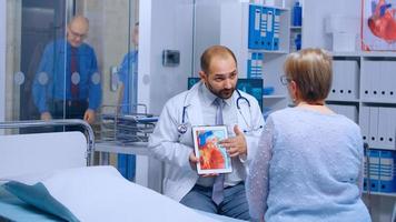 médico explicando doença da artéria coronária
