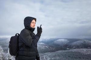 homem no topo da montanha no inverno foto