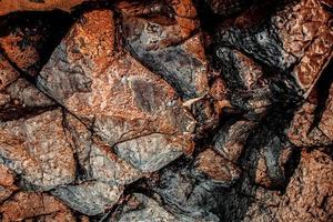 textura de pedra de rocha marrom isolada e enorme coleção de fundo de pedras de granito foto