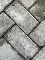o arranjo de pavimento arrumado para textura de fundo de rua. textura áspera e envelhecida do material de concreto.