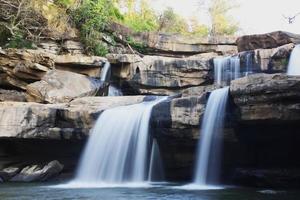 bela cachoeira panorâmica bela floresta natural profunda e preta rocha verde na natureza. foto