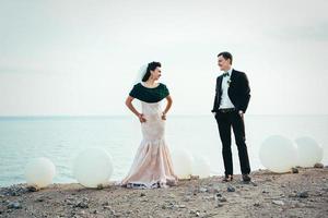 o noivo em um terno marrom e a noiva em um vestido marfim foto
