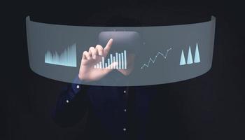 empresário usando óculos de metaverso de realidade virtual para o mundo virtual mostrando crescimento de negócios em gráfico de barras foto