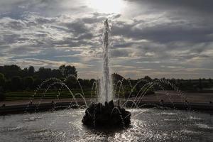 fonte de jardim com céu e nuvem foto