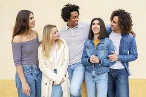 grupo multiétnico de amigos posando enquanto se divertem e riem juntos foto