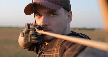 homem com arco ao ar livre no campo foto