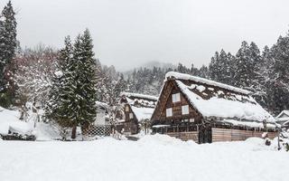 vila de shirakawago com queda de neve na temporada de inverno. Marco de GIFu, Takayama, Japão foto