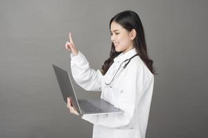 médico de mulher está usando laptop foto
